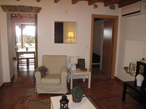 a living room with a chair and a table at Casa do Castelo - Muralha in Castelo de Vide