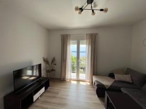 a living room with a couch and a television at Villa Marija in Crikvenica
