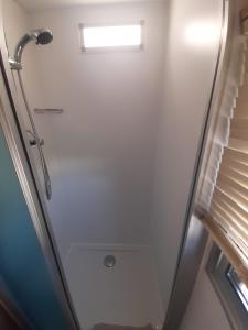 a shower stall in a bathroom with a window at Holiday in Holland - no workmen only holiday makers in Vierhouten