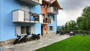 a group of motorcycles parked outside of a building at Agritur LA FENICE in Brez