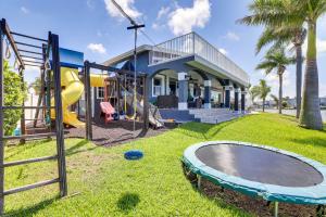 a playground in front of a house at Luxury St Petersburg Home with Pool and Bay Access! in St Pete Beach