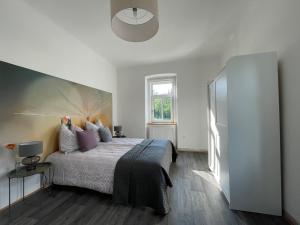 a bedroom with a large bed with purple pillows at Die alte Salzvilla in Bad Aussee