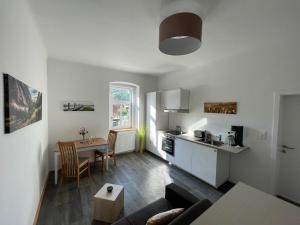 a living room with a kitchen and a dining room at Die alte Salzvilla in Bad Aussee
