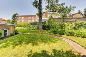 a garden with a tree and a path at Wilmington Vacation Rental Near River and Downtown! in Wilmington