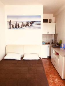a room with a kitchen with a picture of a beach at Studio avec accès direct à mer à Bijela - Appart numéro 1 in Bijela