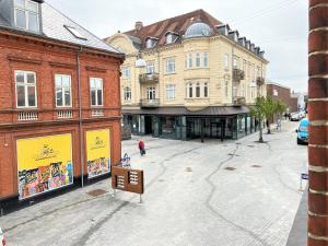 an empty street in a city with buildings at Three Bedroom Apartment In Esbjerg, Kronprinsensgade 20 in Esbjerg