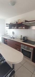 a kitchen with a table and a counter top at Departamento Marina Sol III in Coquimbo