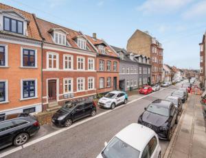 a street with cars parked on the side of the road at Nice Apartment In A Quite Street In The City Center in Aarhus