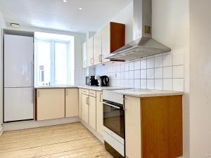 a kitchen with a sink and a stove top oven at Nice Apartment Located Near Vesterbro in Aalborg