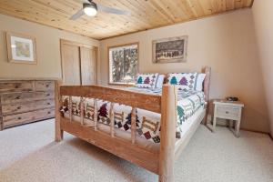 a bedroom with a wooden bed and a wooden ceiling at Hikers Haven -Only steps to the National Forest and trails! in Big Bear City