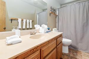 a bathroom with a sink and a toilet at Hikers Haven -Only steps to the National Forest and trails! in Big Bear City