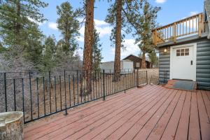 a wooden deck with a white door and a fence at Casa Luna- Beautiful Maltby style home, just a short drive from Big Bear's attractions! in Big Bear City
