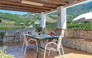 a patio with a table and chairs on a balcony at La Era in Frigiliana