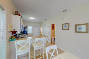 a kitchen with a counter and stools in a room at Laguna Jewel in Port Isabel