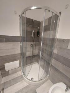 a glass shower in a bathroom with a toilet at La grazia in qualche modo in Siniscola +22 photos