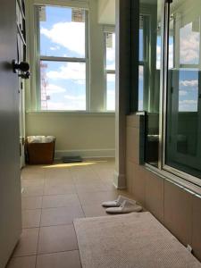 a bathroom with a window and a towel on the floor at 5-star Luxury Apartment - Atop the Seagle Building in Gainesville +16 photos