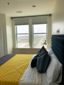 a bedroom with a bed with a large window at 5-star Luxury Apartment - Atop the Seagle Building in Gainesville