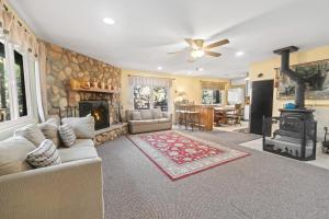 a living room with a couch and a fireplace at Irie's Retreat - Perfect location for multi-generational groups! Sauna, hot tub, Jungle gym! in Sugarloaf