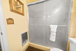 a bathroom with a glass shower door with a towel at Irie's Retreat - Perfect location for multi-generational groups! Sauna, hot tub, Jungle gym! in Sugarloaf +17 photos