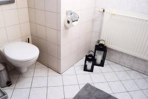 Un baño blanco con inodoro y lavabo. en Wattwürmchen, en Wremen