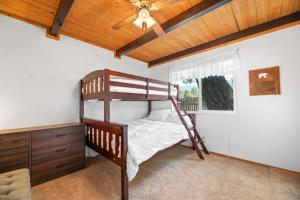1 dormitorio con litera y ventilador de techo en Lazy Bear Cabin -Beautiful mountaineer style cabin with wood ceilings and beamed accents, en Big Bear City