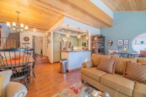 a living room with a couch and a table at Junipine Lakefront Condo - Walking distance to the lake! Less than 2 miles from the slopes! in Big Bear Lake
