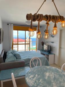 a bedroom with a bed and a table with a view at Apto One More Day in Ambar in Calpe