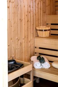a sauna with wooden walls and two beds with towels at Old Town Vistula Premium Apartments in Kraków