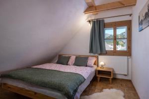 a small bedroom with a bed and a window at Chalupa Bocza in Nižná Boca