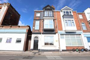 an apartment building on a city street at Newly refurbished studio with harbour views in Lowestoft