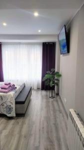 a bedroom with a bed and a tv in a room at Ca Lolina Playa in Gijón