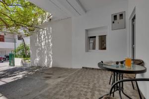 a room with a table and a white wall at Sunny Garden Apartments Ana in Makarska