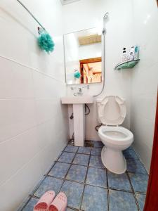 a bathroom with a toilet and a sink and a mirror at Hanok Moryeon in Jeonju