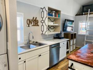 a kitchen with white cabinets and a sink at Walleye Rentals in Glendo