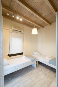 two beds in a room with a window at Marina View in Limenas