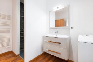 a white bathroom with a sink and a mirror at La Terrasse Du Gibet in Montigny-lès-Metz +7 photos