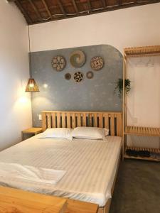 a bedroom with a large bed with plates on the wall at Blue Sea Homestay 2 in Phu Yen