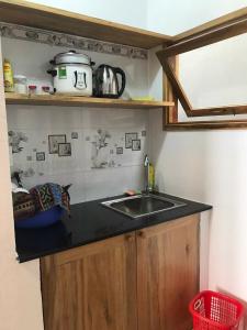 a kitchen with a sink and a counter top at Blue Sea Homestay 2 in Phu Yen