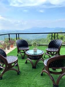 a group of chairs and a table on a balcony at Tanay Panoramic Mountain View Cabin 