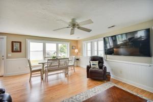 a living room with a table and chairs and a ceiling fan at Gloucester Point Vacation Rental on York River! in Yorktown