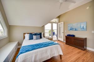 a bedroom with a large bed with blue pillows at Gloucester Point Vacation Rental on York River! in Yorktown