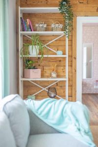 a room with a book shelf with plants on it at Manni's house with garden & playground in Kuressaare