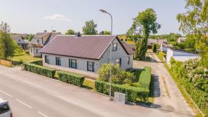 a house on the side of a road at Manni's house with garden & playground in Kuressaare