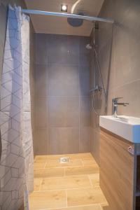 a bathroom with a shower and a sink at Manni's house with garden & playground in Kuressaare