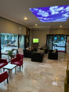 a large living room with couches and chairs and a ceiling with aperature at Cleopatra King Apart in Alanya