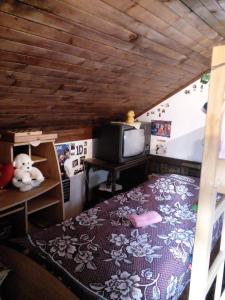 a bedroom with a bed in a doll house at Vikendica Vukovic in Foča