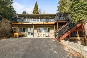 a house with a balcony and a driveway at Family Fun Cabin - Mountain home with Game Room, Hot Tub and Lake Views! in Fawnskin