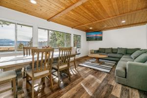 ein Wohnzimmer mit einem Sofa und einem Tisch in der Unterkunft Family Fun Cabin - Mountain home with Game Room, Hot Tub and Lake Views! in Fawnskin