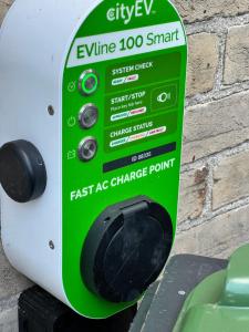 a green and white detergent dispenser on a brick wall at The Grange in Weymouth