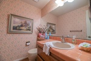 a bathroom with a sink and a toilet at Lakefront Viking Oasis - Beautiful Viking Estates condo complex on the lake! in Big Bear Lake +12 photos